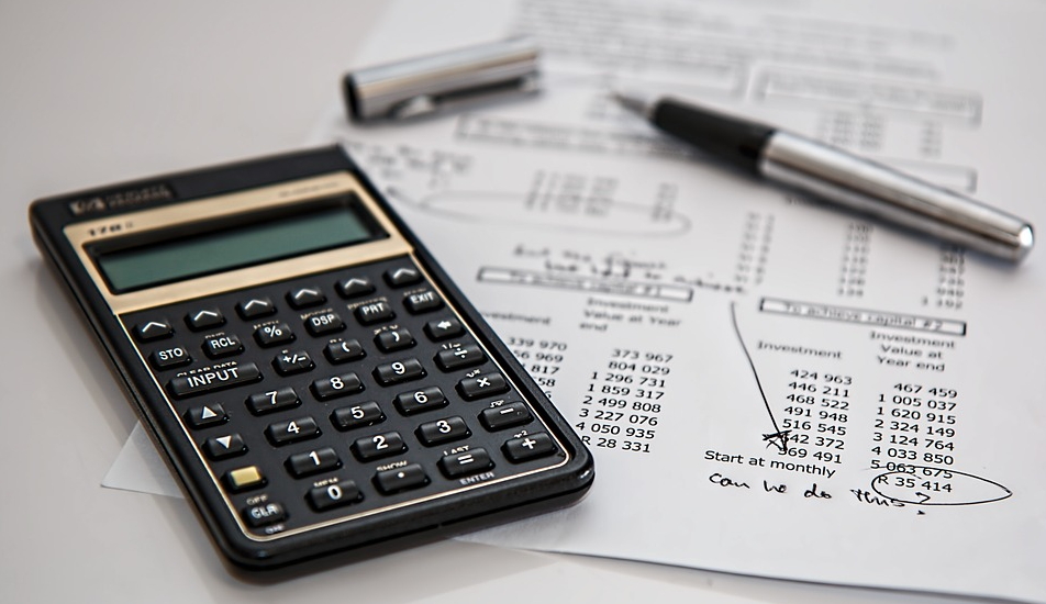 calculator and pens on a desk