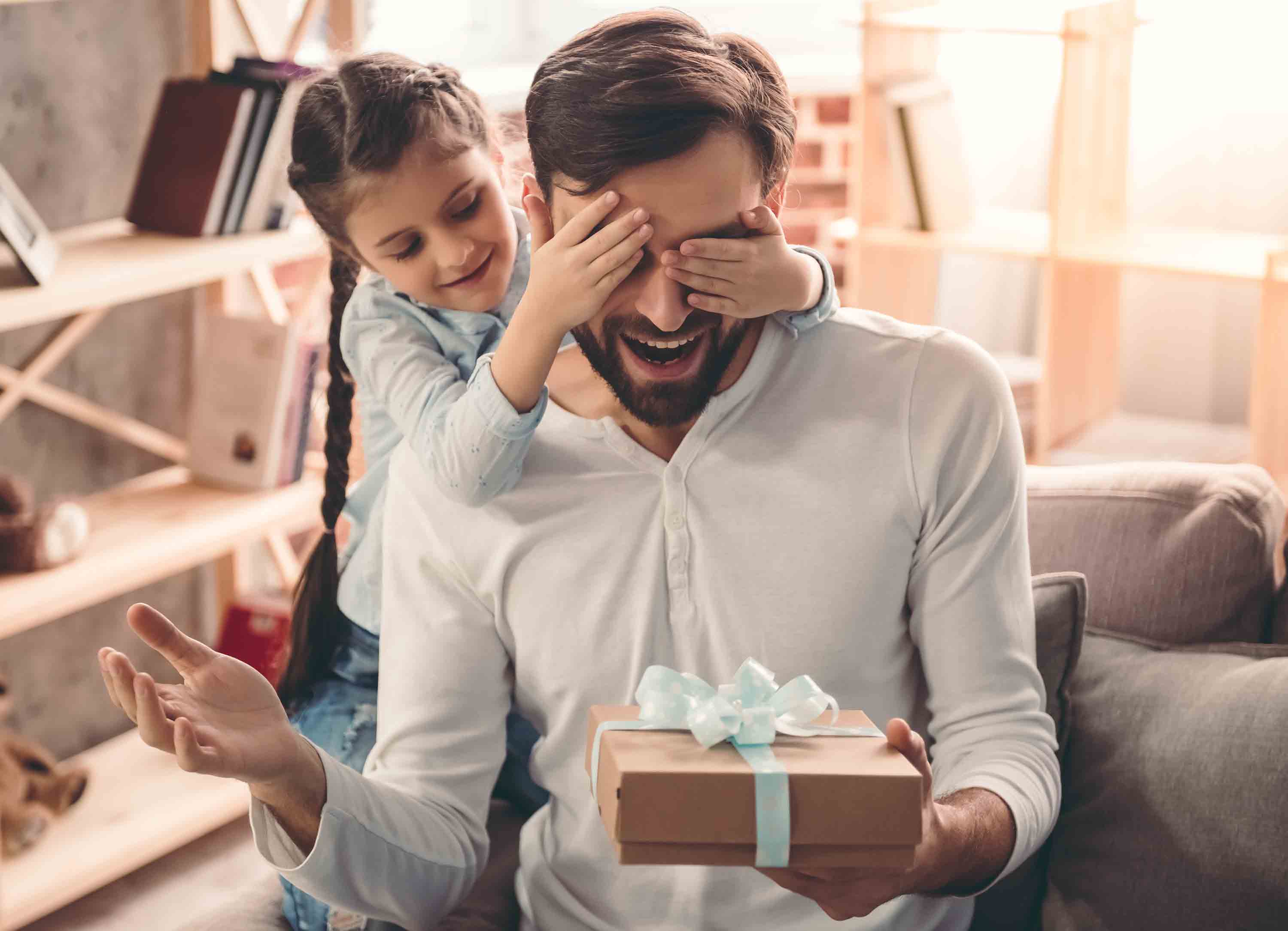 A little girl gives Dad a birthday present